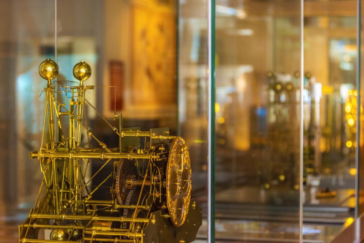 A beautifully intricate clock inside a display case at the Royal Observatory