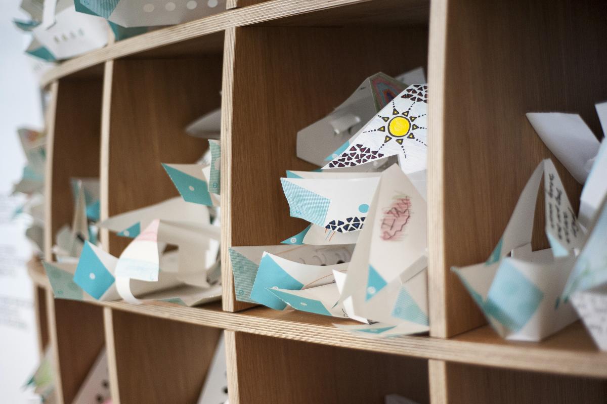 Colourful paper boats in shelves