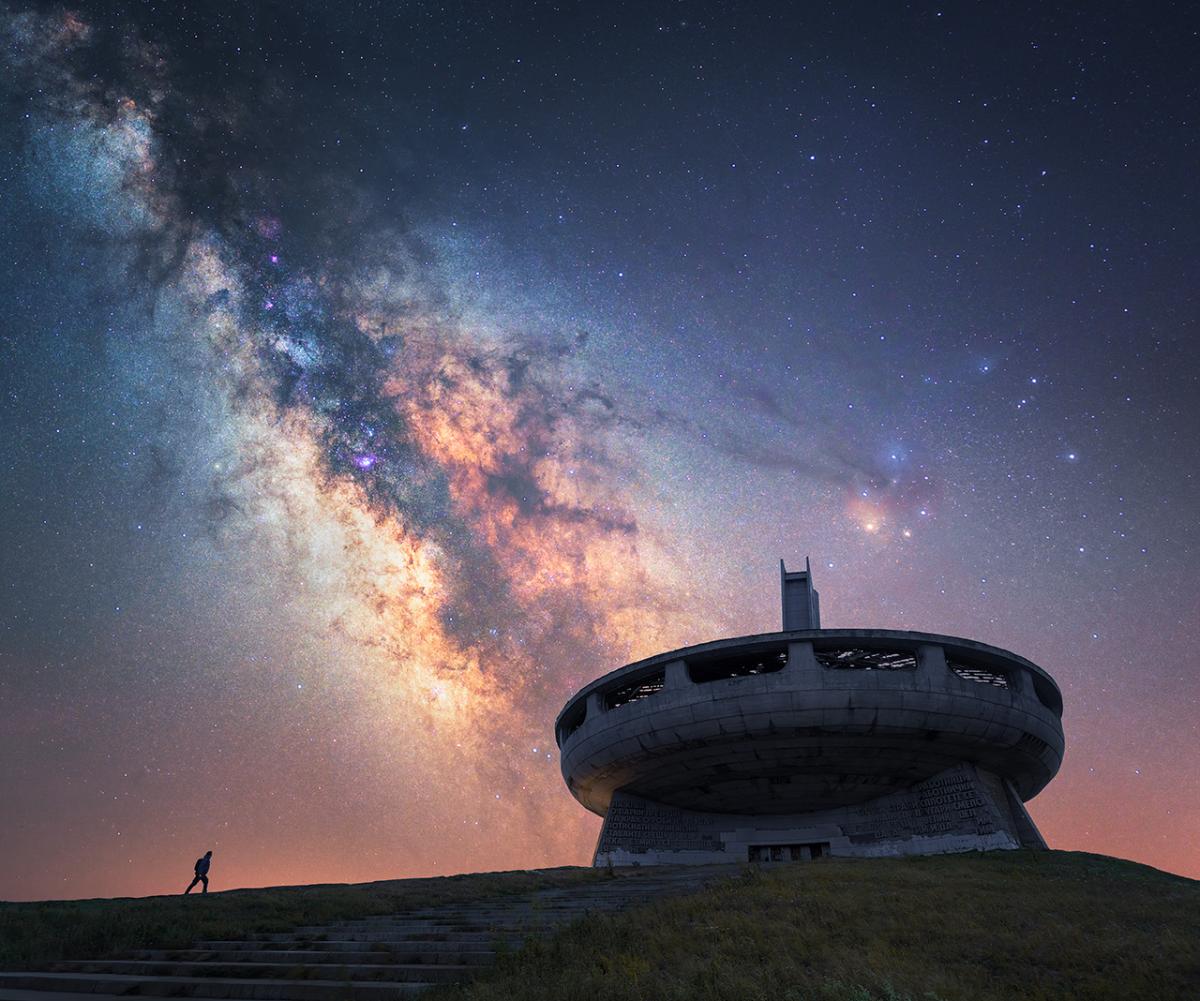 Monument in Balkan mountains with luminous skyscape