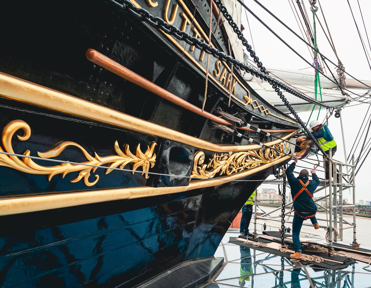 Shipkeepers work to reattach the figurehead to historic ship Cutty Sark