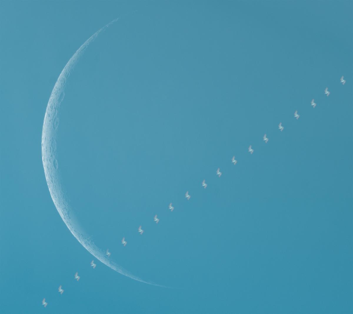 International Space Station passes in front of the crescent moon