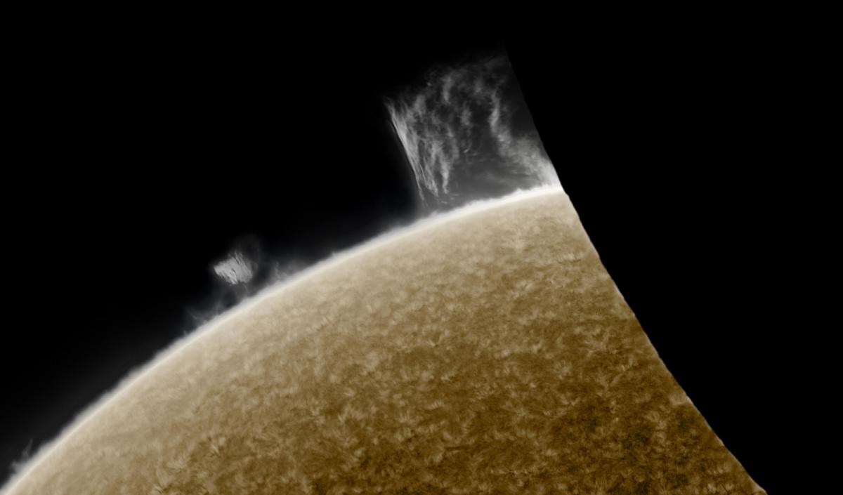 Close up telescope view of the Sun during an eclipse. A dark shadow has blocked out around a third of our view of the Sun, leaving just a bright orange triangle of light