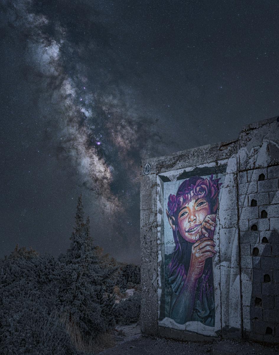 Image of Pandora on the wall of an abandoned hotel on a beach