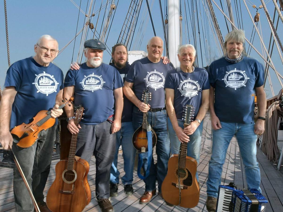 Shanty group, Swinging the lead, stood on the weather deck of Cutty Sark