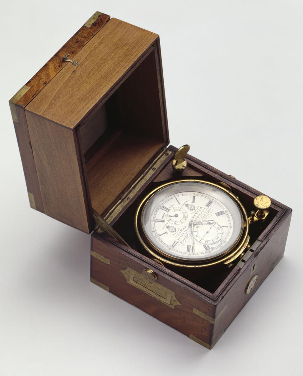 A marine chronometer housed inside a wooden case