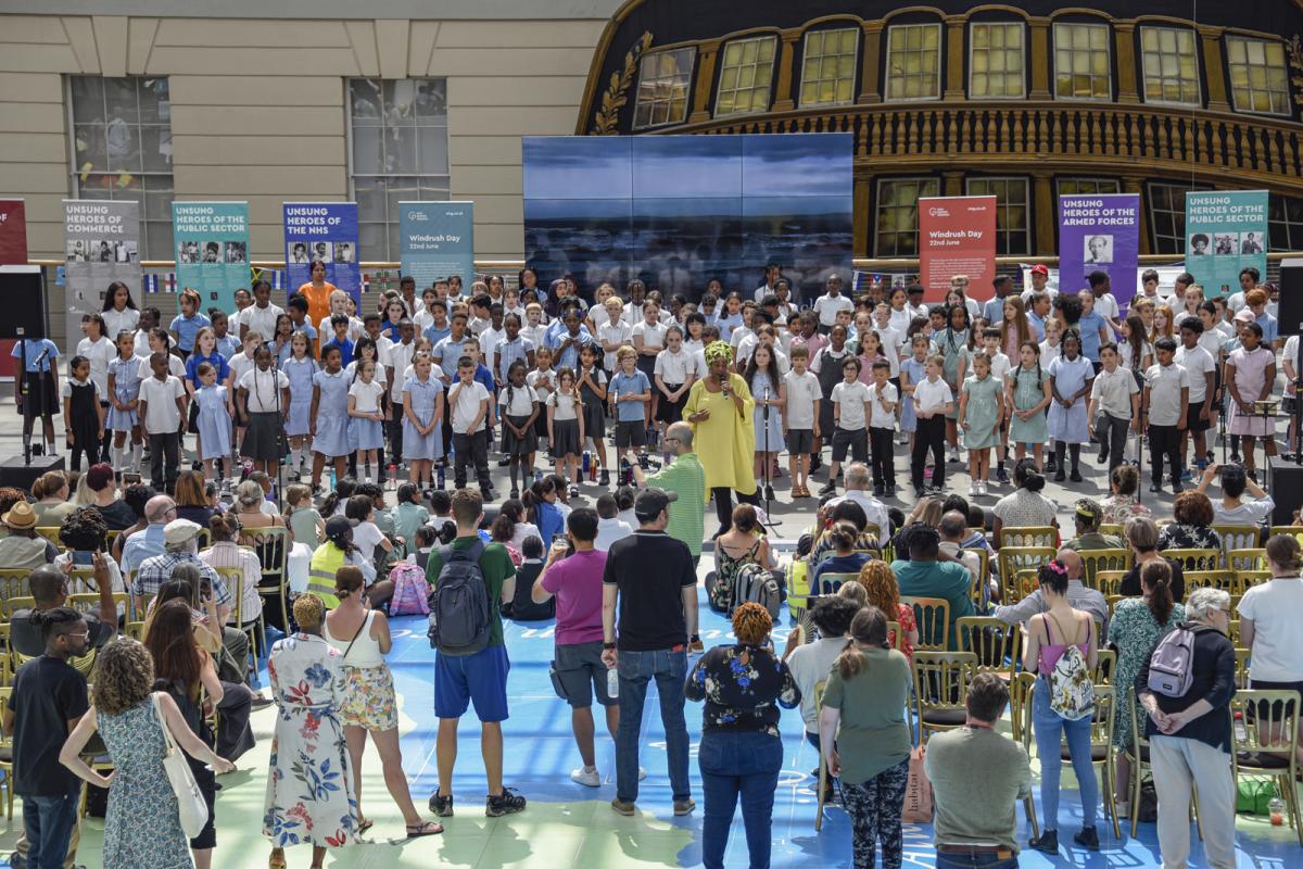 Choir performance on the Great Map of the National Maritime Museum, with crowds looking on