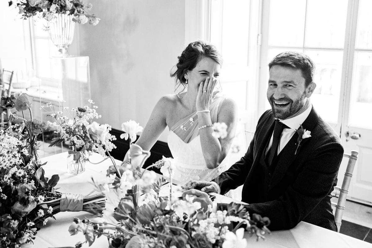 Couple laughing during wedding ceremony - credit to Natasha Hurley