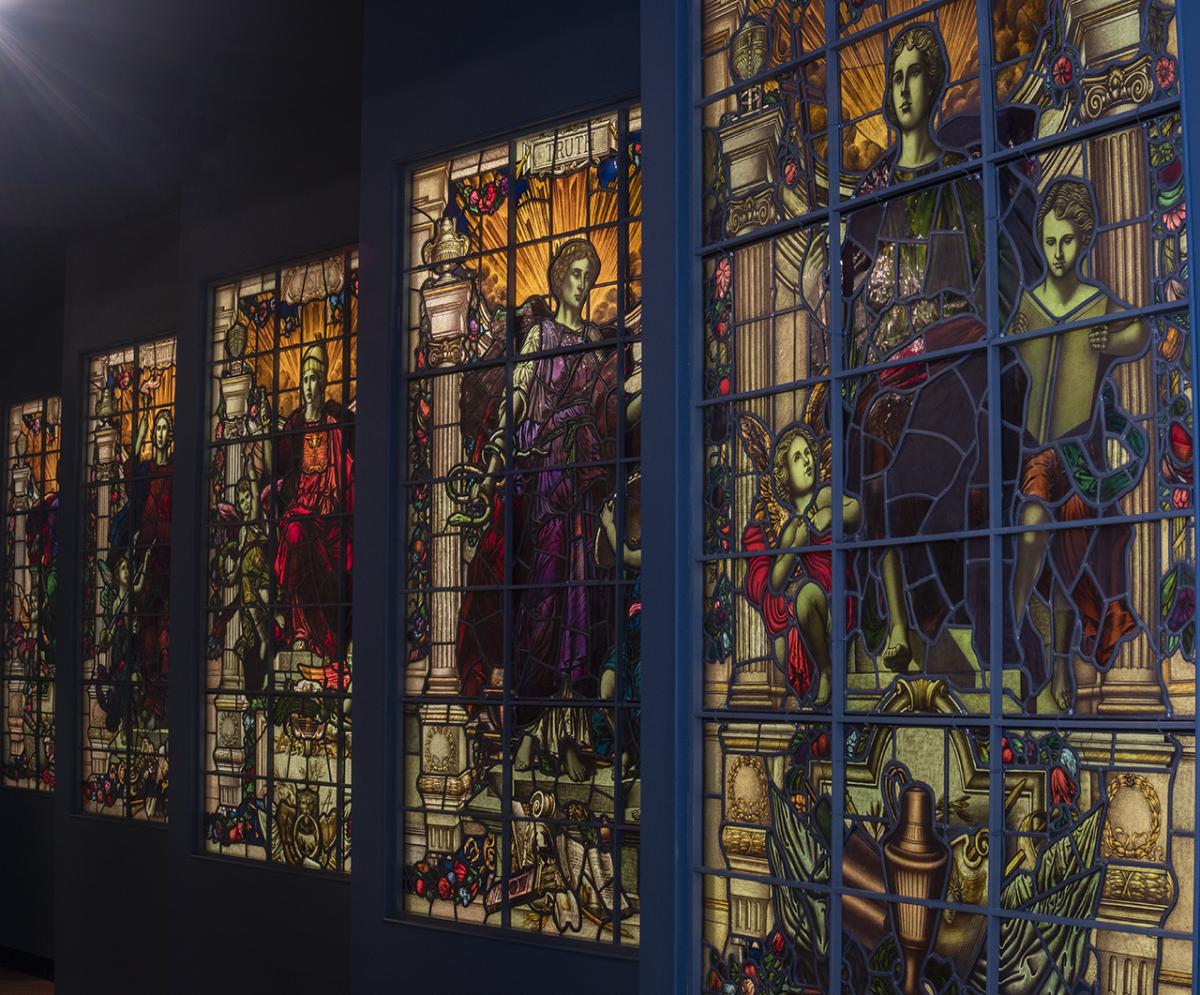 A series of five vertical stained glass windows