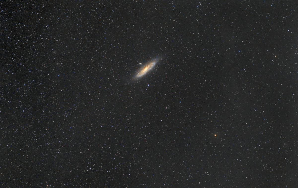 Image of dark starry night sky with a bright white oval around 3mm across which is the Andromeda Galaxy seen from a long distance