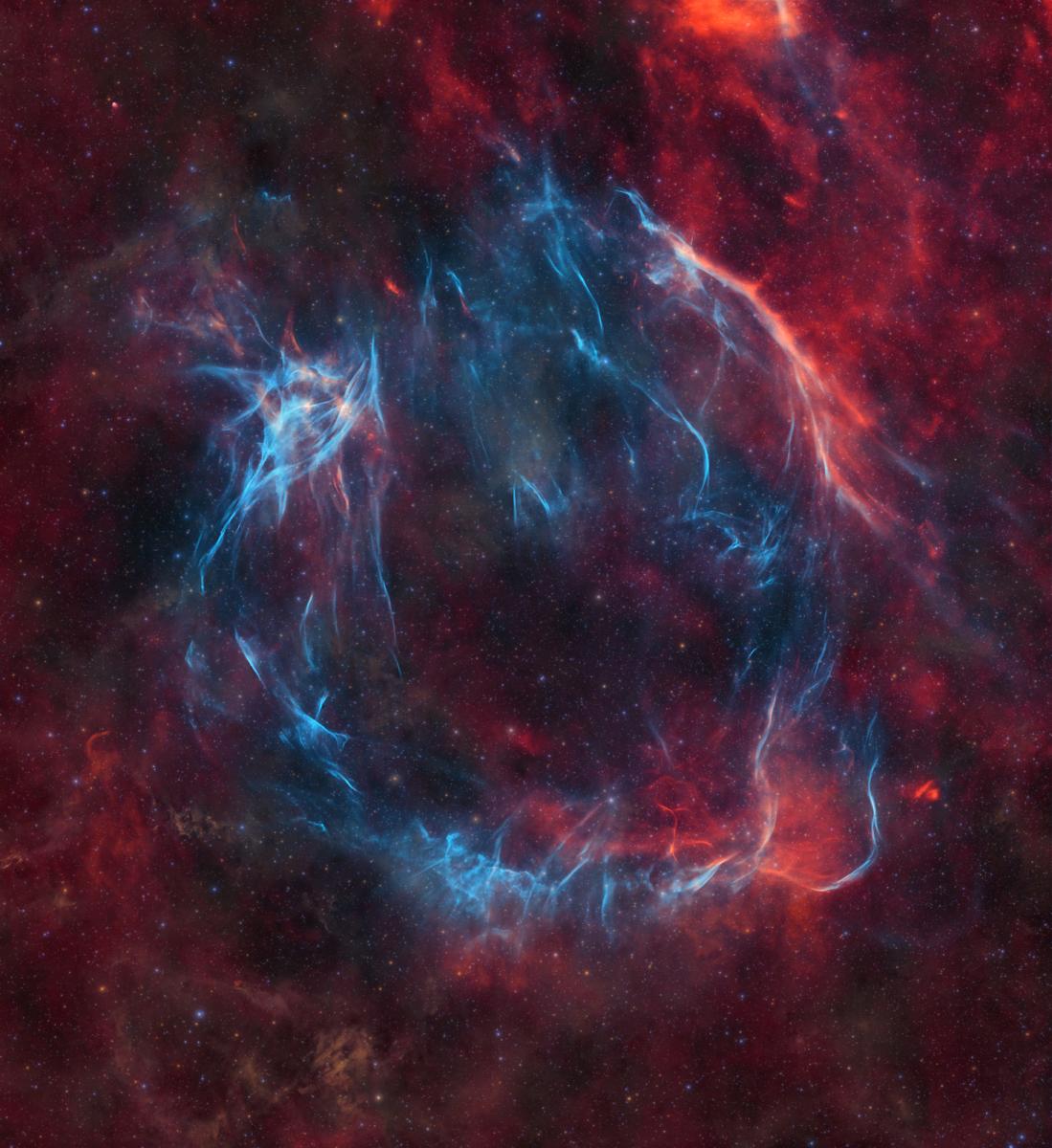 A swirling red and blue supernova