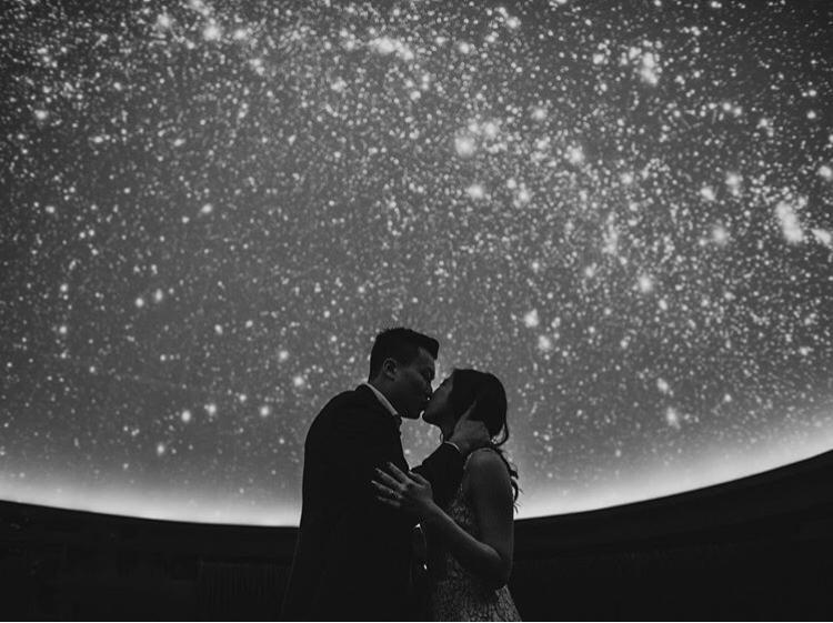 A couple kissing in the Planetarium