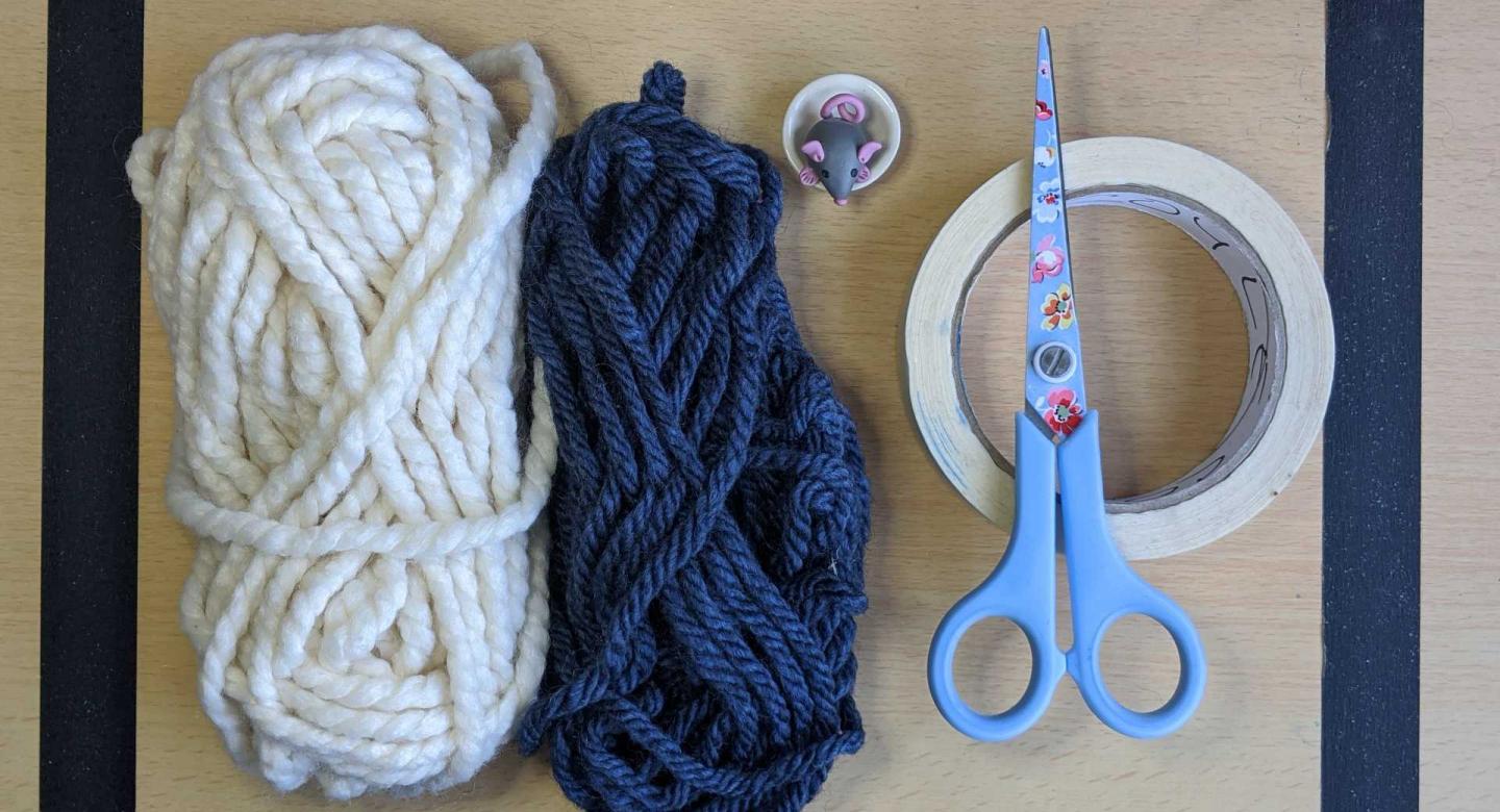 white wool, blue wool, tape, scissor, mouse in a pot