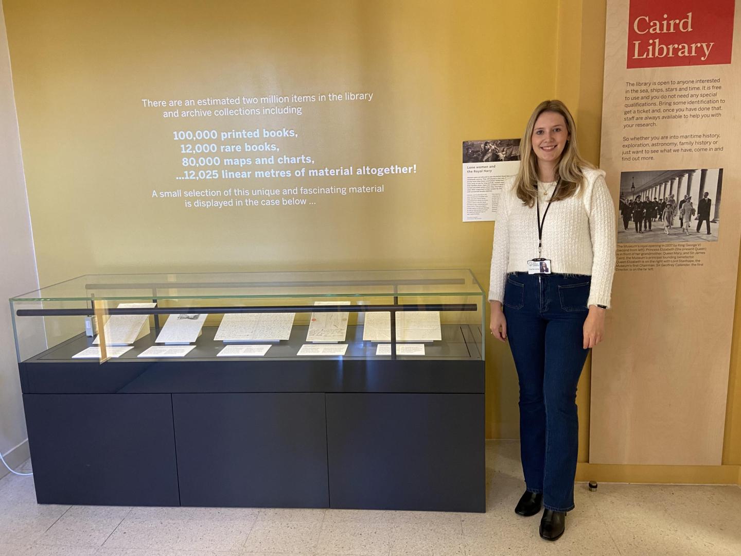 photo of a display case with a woman standing beside it
