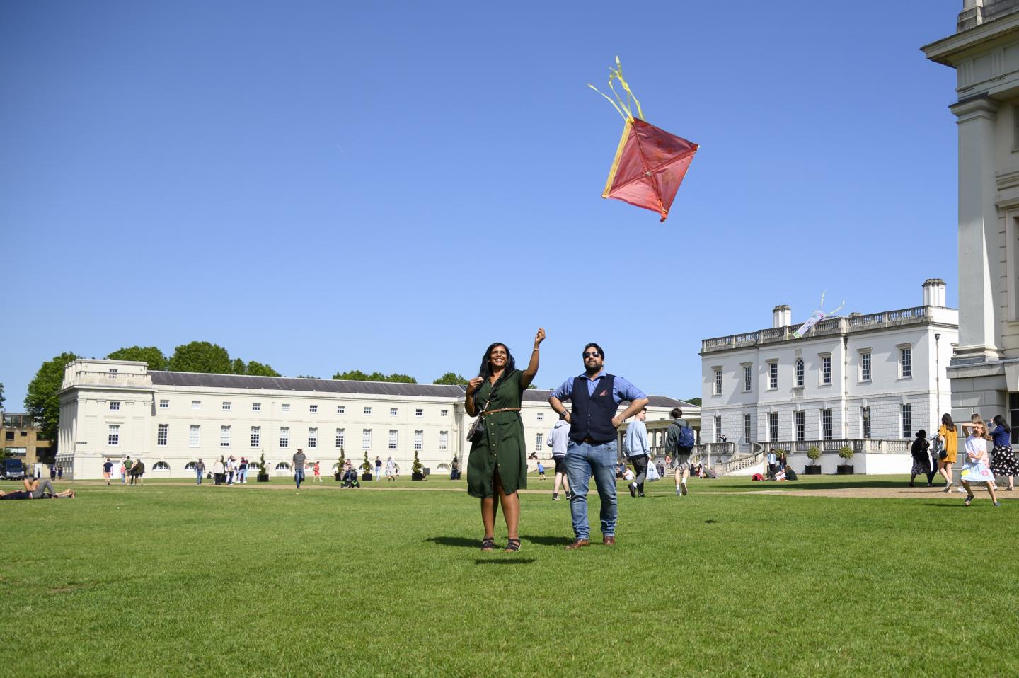 woman with a man. She is flying a kite.