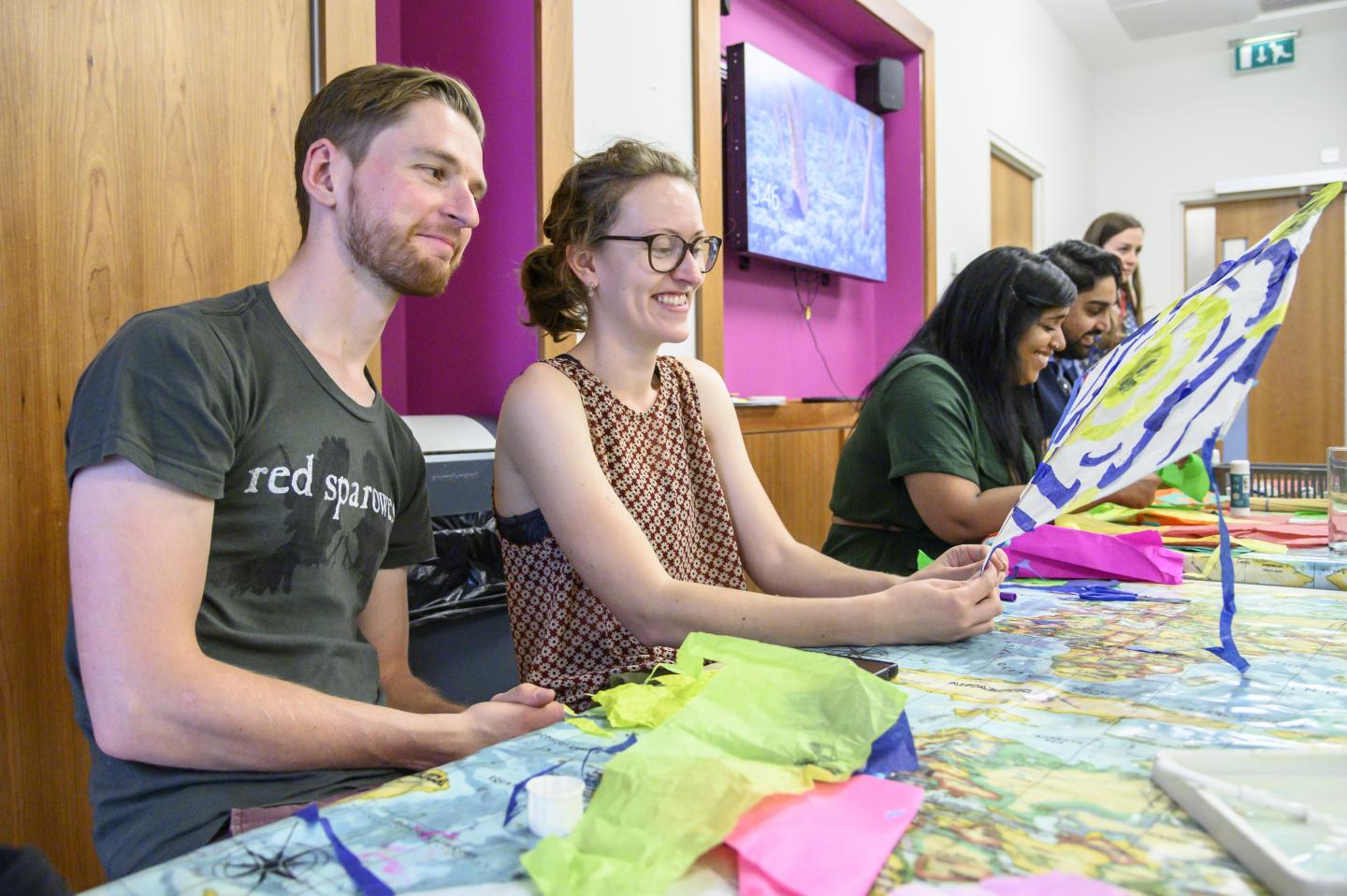 men and women making kites