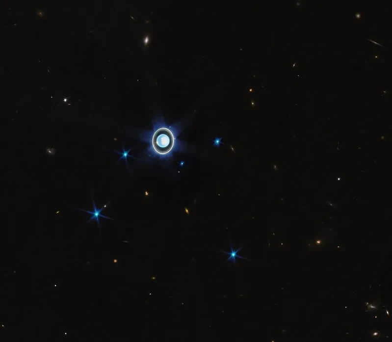 Image of blue round planet which is Uranus, with a blue ring around it