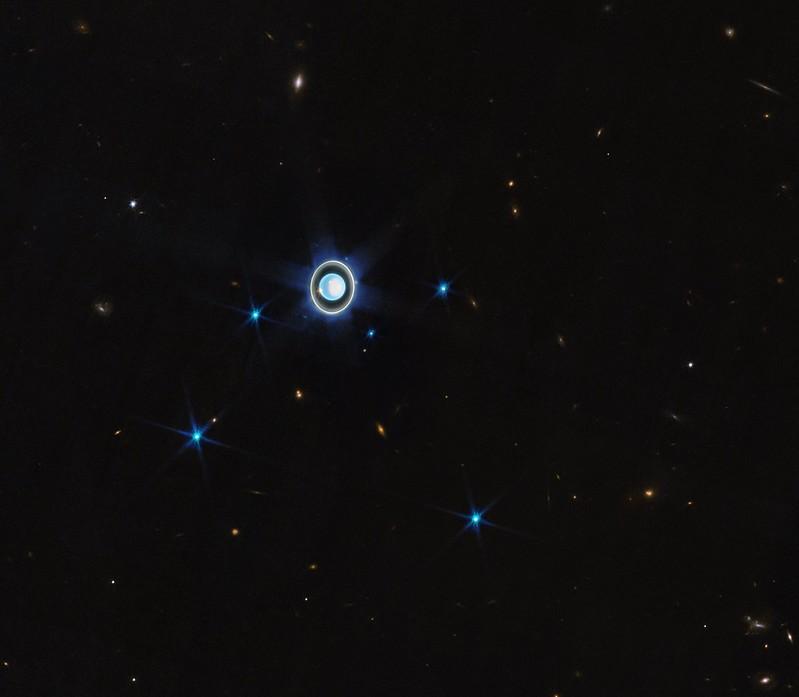 Image of blue round planet which is Uranus, with a blue ring around it 