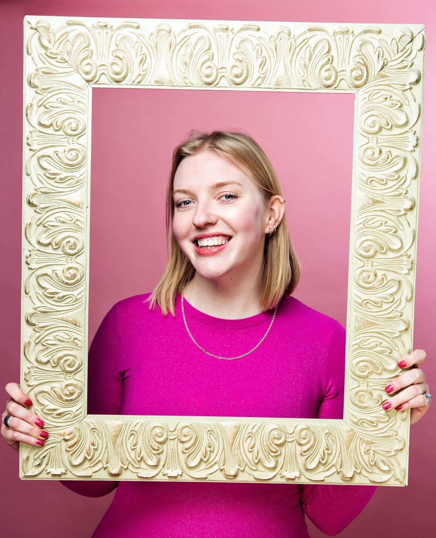 Girl holding a gold frame 