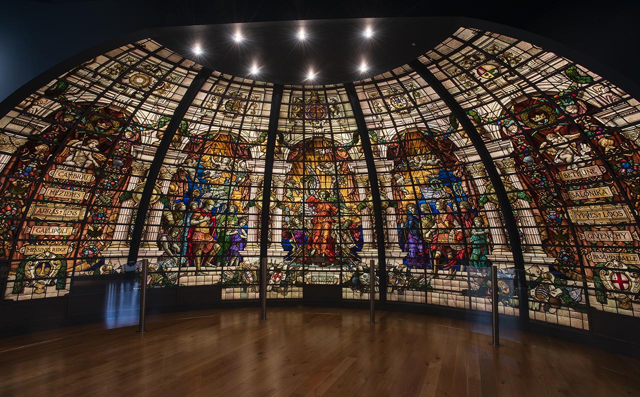 Five stained glass panels in a half-dome formation depicting classical figures