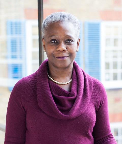 Professor Dame Donna Kinnair wearing a purple jumper and white necklace 