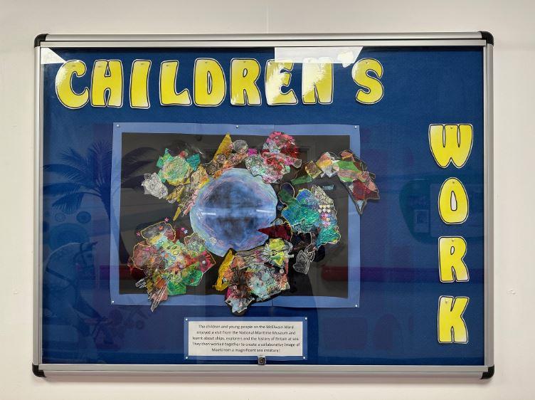 A notice board that says 'children's work'