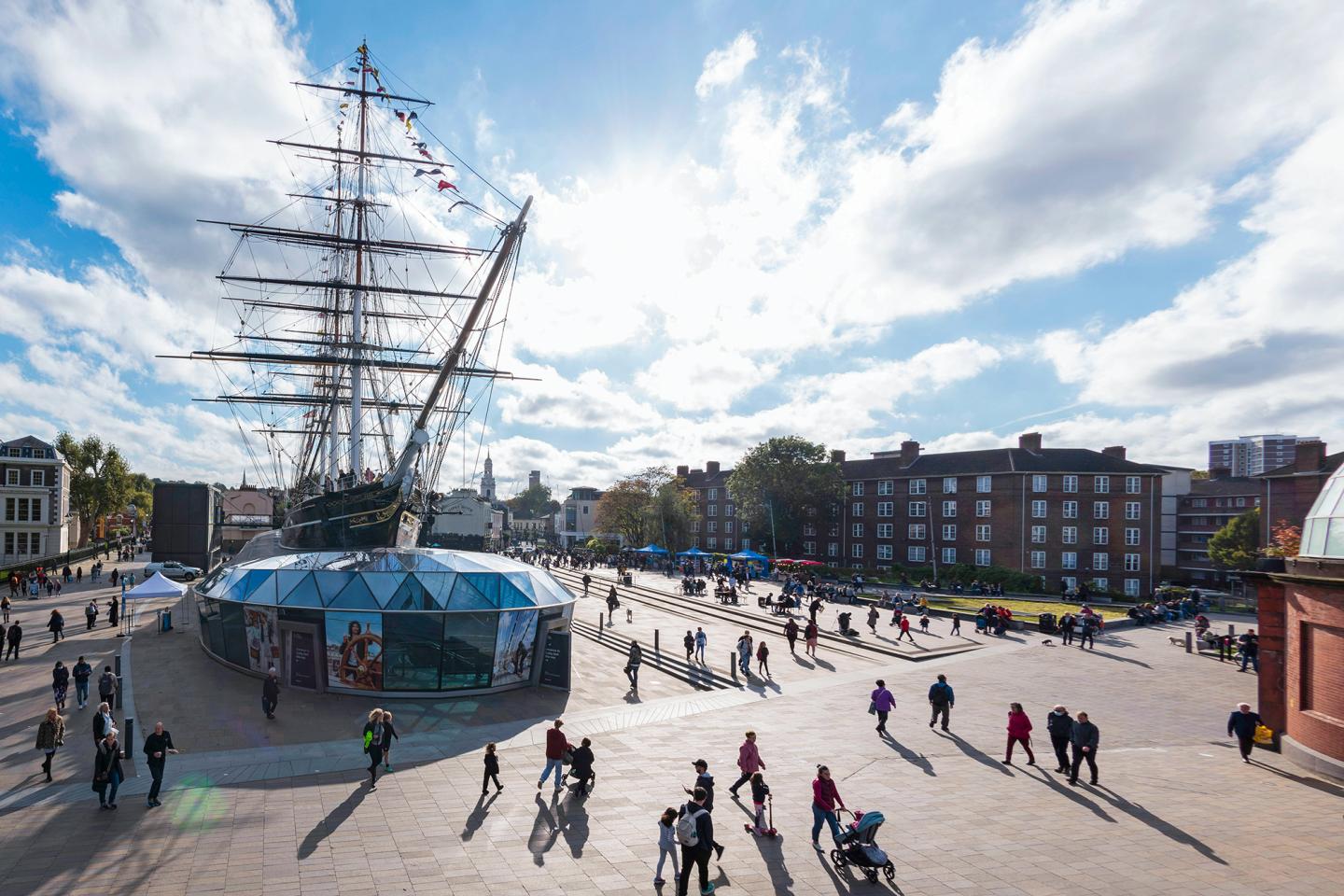 View of Cutty Sark and people walking around the ship 