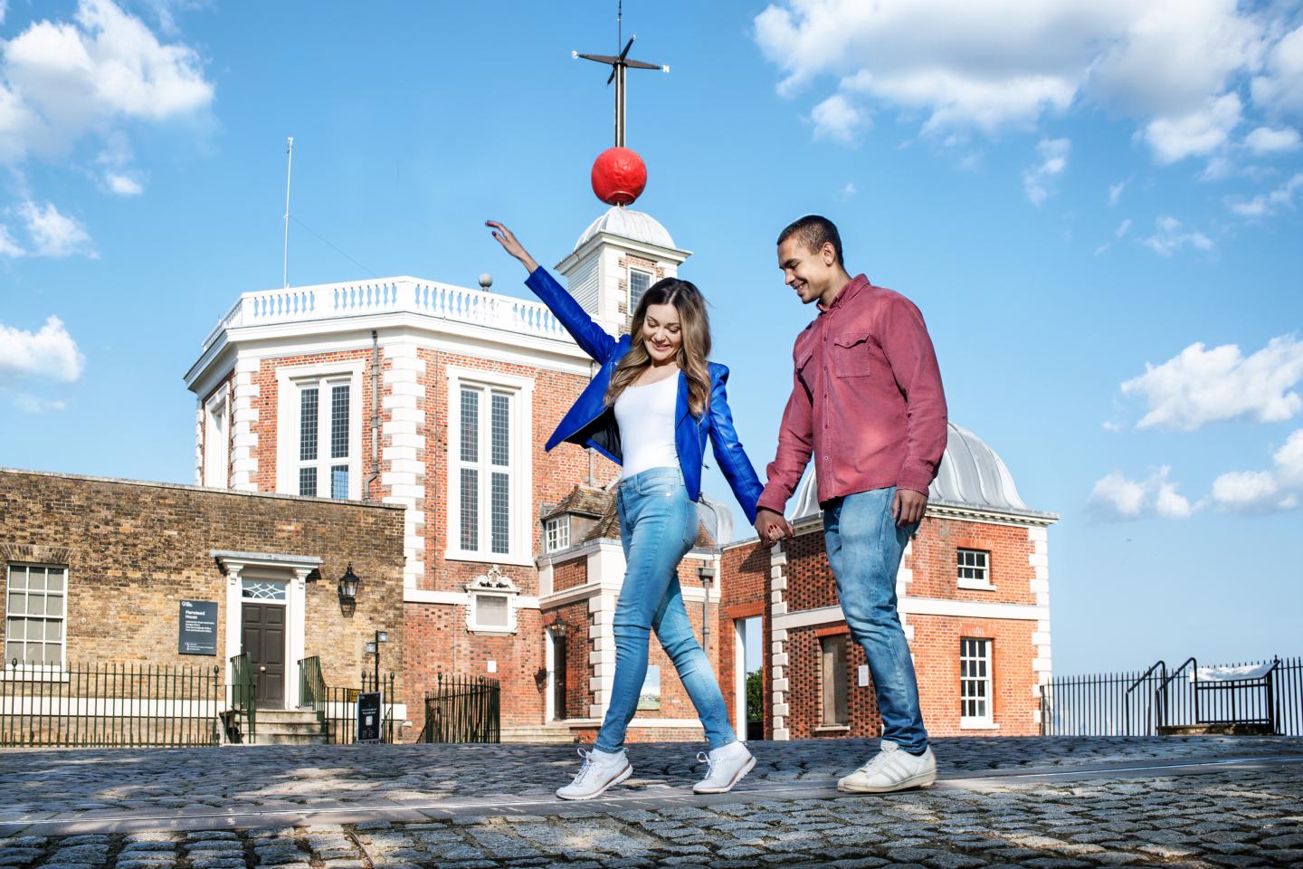 Two people walking on the Meridian Line at the Royal Observatory