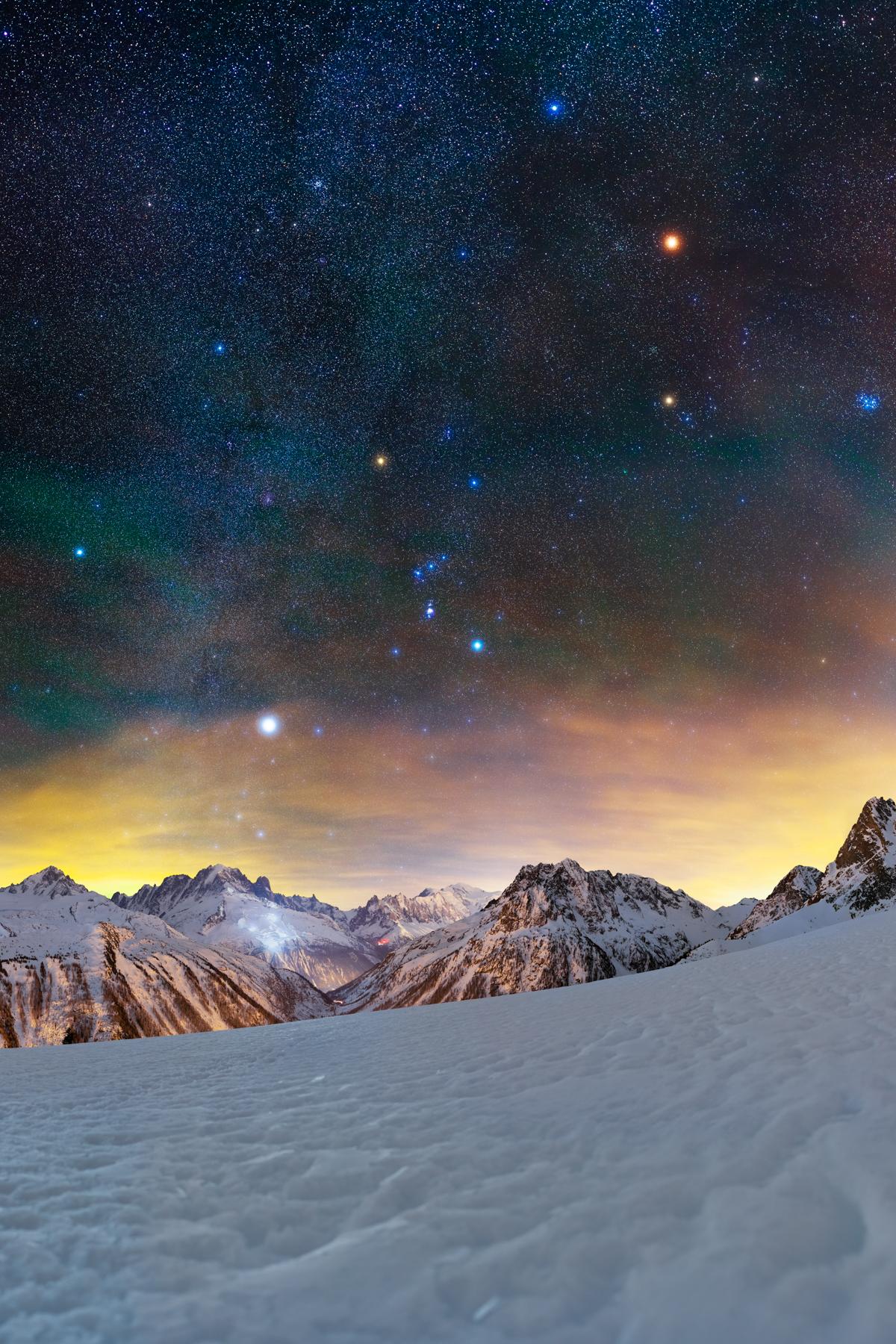 Bright stars glow above the snowy French Alps