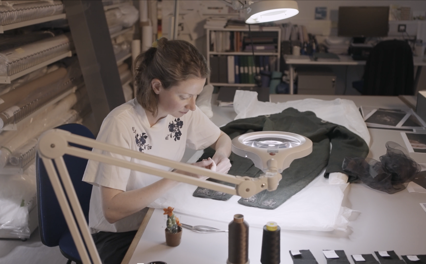 Conservator Aisling Macken working on the embroidered eagles on the Hare uniform