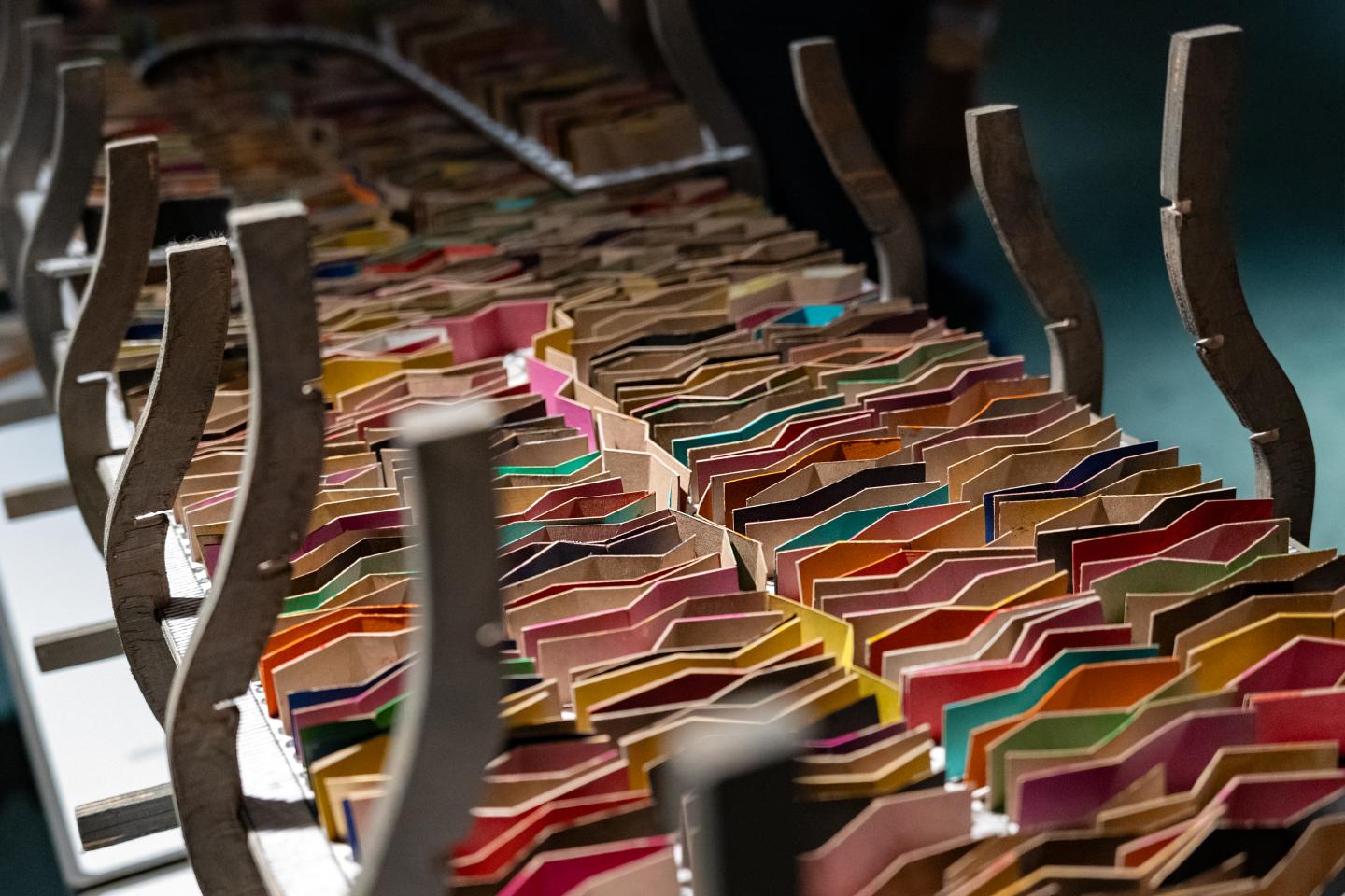 A model of a ship filled with colourful cardboard zigzag makers