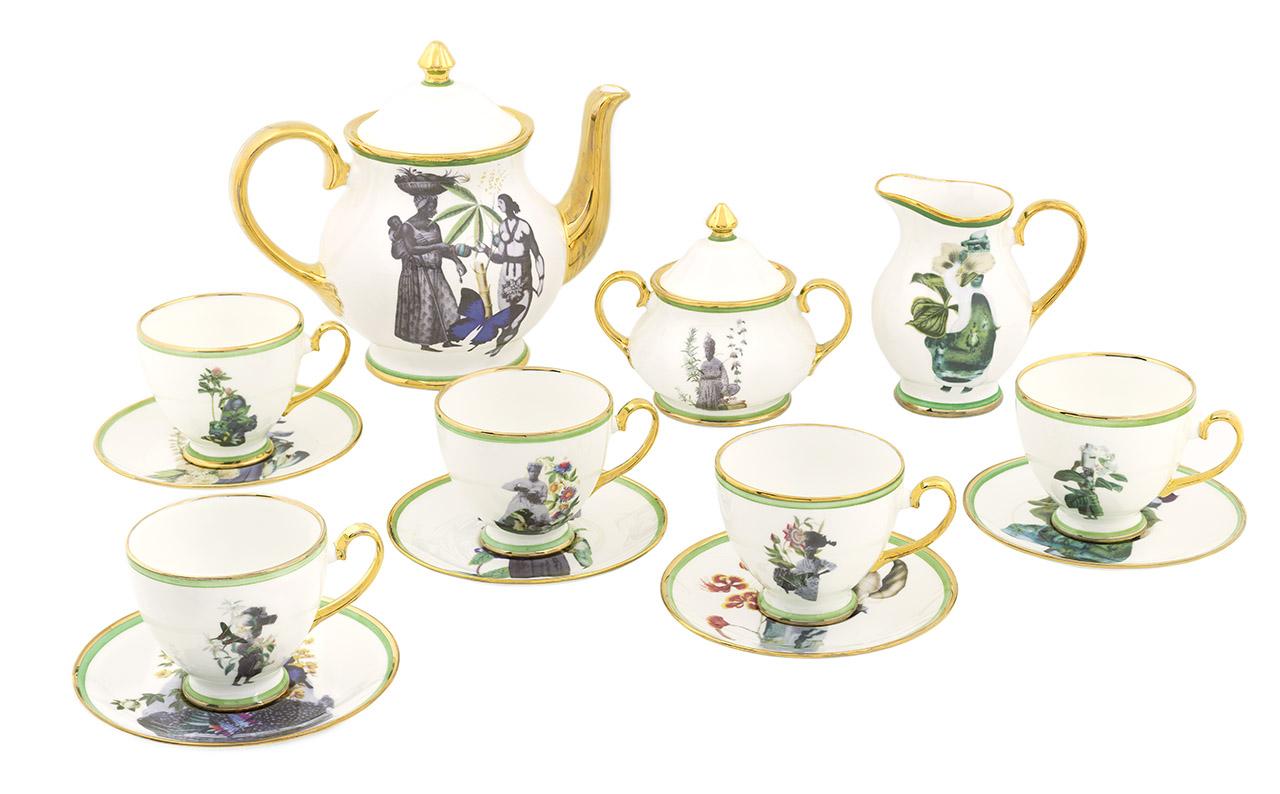 A tea service featuring cups, sauces and a teapot adorned with images of women and plants