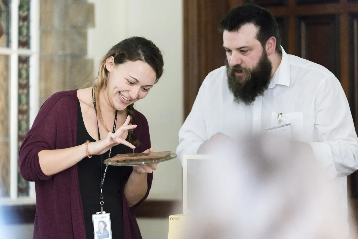 Two people looking a chocolate melting on a plate.