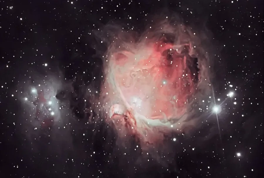Astronomy photograph of the Orion Nebula in a starry sky.