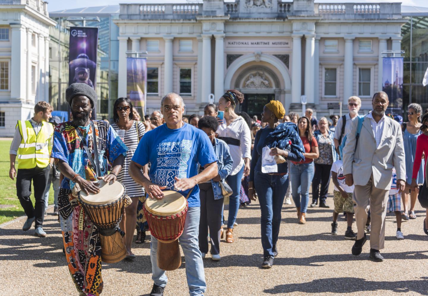 Photo of drummers leading a parade outside the National Maritime Museum